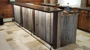 Bar with a metal counter top and reclaimed wood front