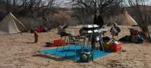 Front seat set up as a table at a riverside camp