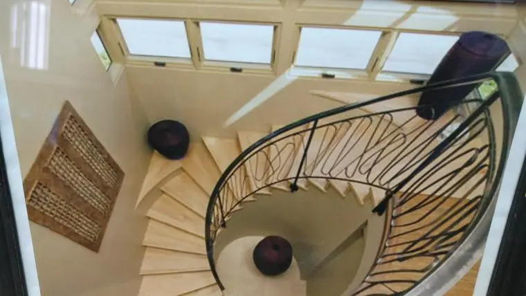 Curved steel handrail on a spiral staircase, seen from above