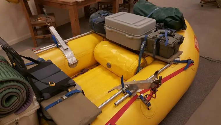 Yellow raft with a Welfelt frame and the front seat loaded with gear