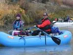 Passenger riding in the front seat of a raft