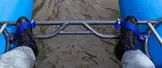Feet on the foot bar, held by foot straps