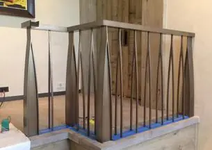 Steel stair railing with a wood cap rail