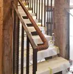 Stair railing with a wood handrail