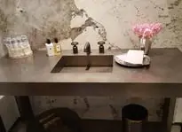 Bathroom vanity with a metal counter top and integrated sink